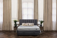 Posteľ do spálne s čalúneným roštom a úložným priestorom Misel - 180x200, Nohy čierny  šedá posteľ z wysokim wezglowiem 